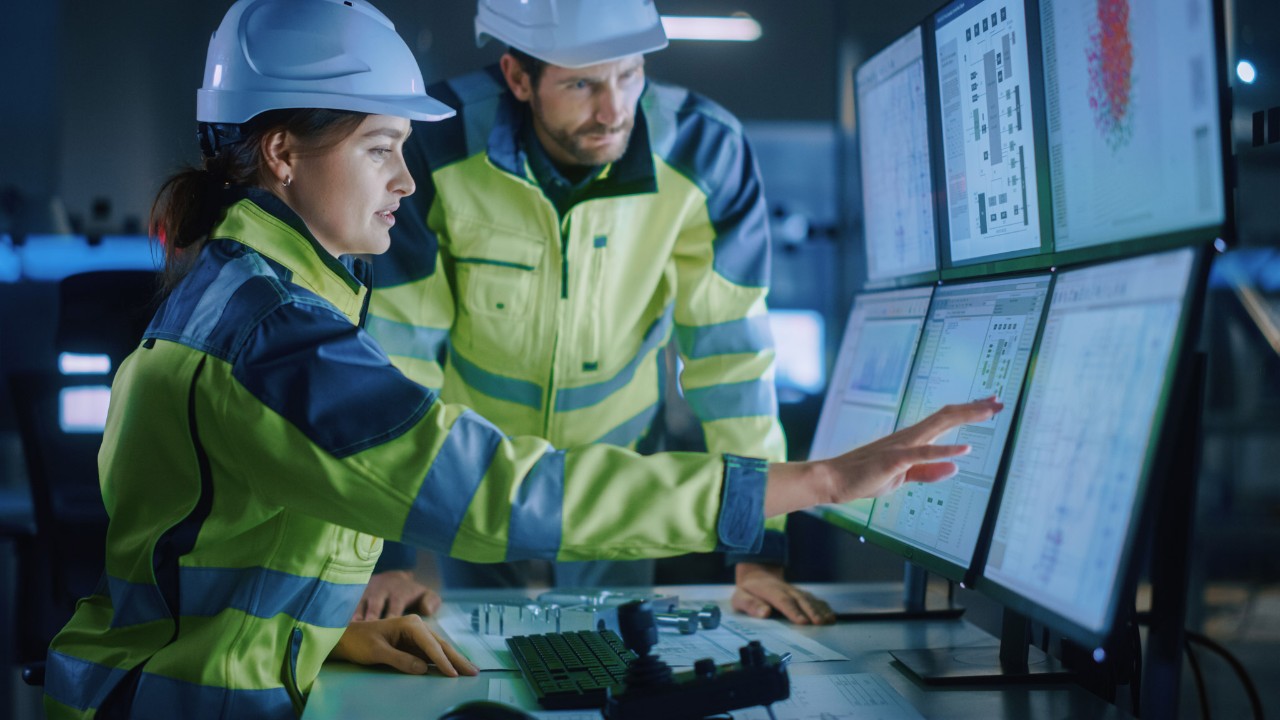 Construction workers looking at a computer