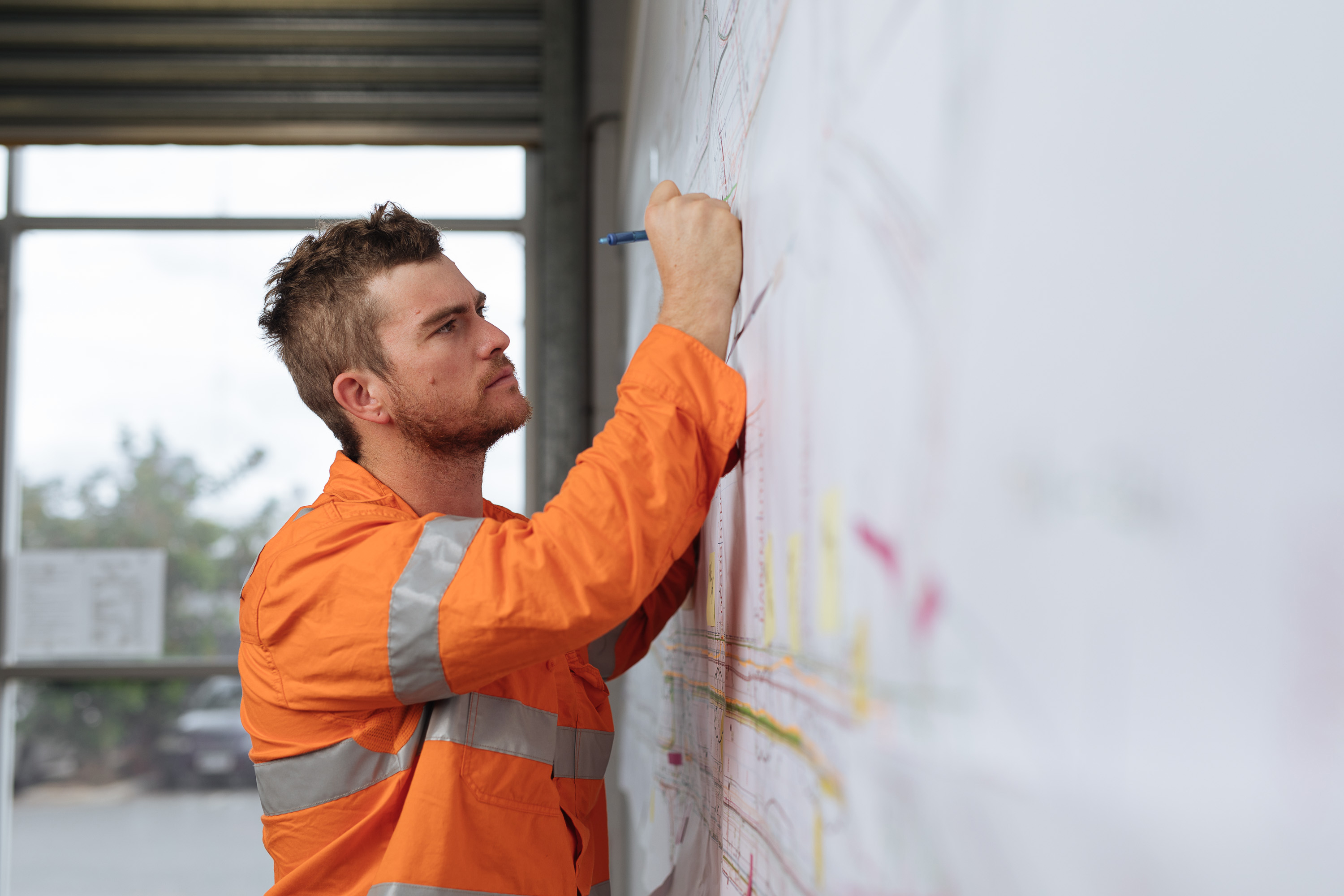Construction Worker writing on whiteboard