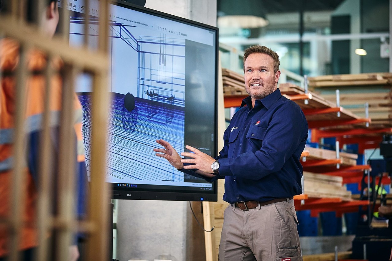 Teacher standing in front of a screen providing instructions
