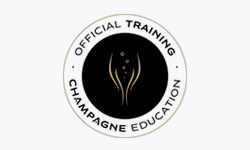 Circular logo for Champagne Education with a black center featuring a gold abstract champagne flute and bubbles, surrounded by a white ring with gold text reading 'OFFICIAL TRAINING' at the top and 'CHAMPAGNE EDUCATION' at the bottom.