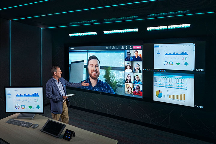 Finance teacher conducting a virtual classroom with engaged students on screen.