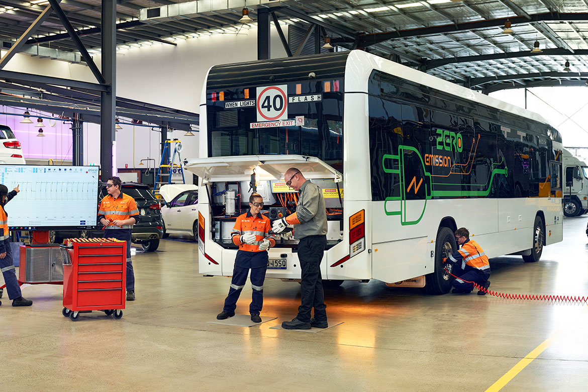 Mechanics in a workshop working on an electric bus