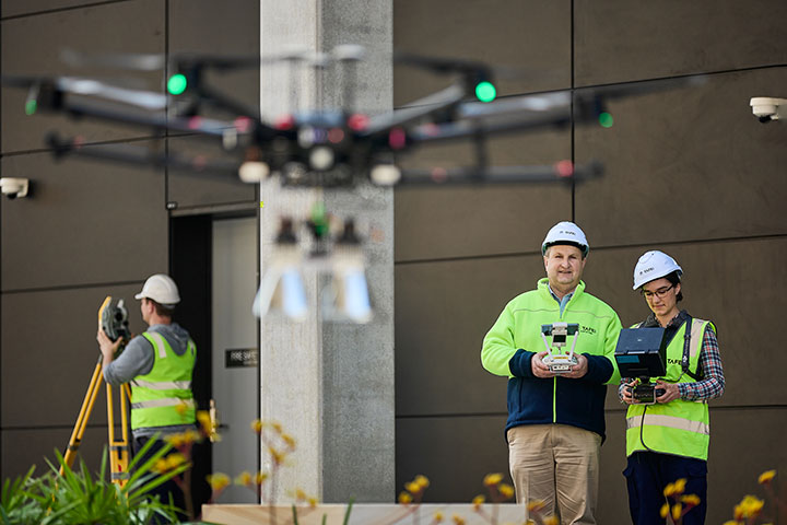 Student learning from teacher on how to be a drone pilot.