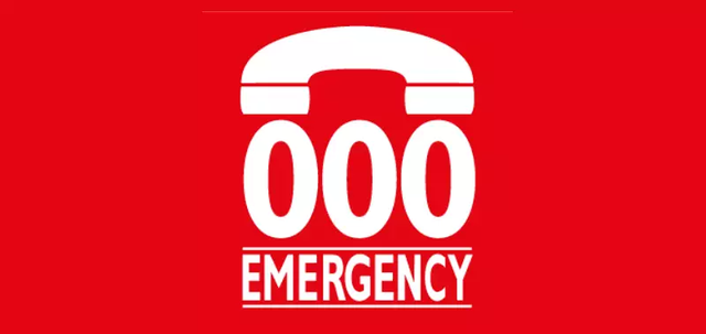 A telephone graphic sits above 000 and the word ‘emergency’ in capital letters. The background is red and the graphic and writing is white.