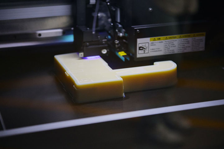 A 3D printer in action at the Institute of Applied Technology (IAT) producing unique objects efficiently and with minimal waste.