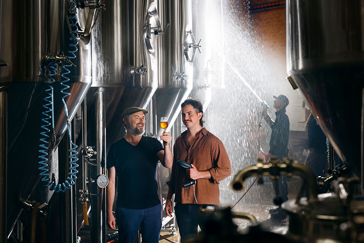 Student and teacher in a microbrewery, learning the craft of brewing