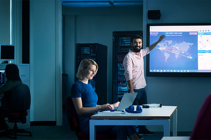 Teacher delivering a comprehensive presentation to a group of attentive students, fostering knowledge and skills in the realm of digital security.