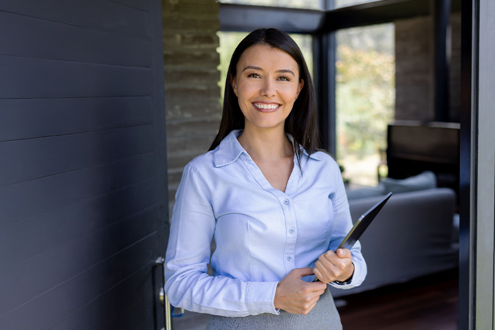 Professional woman holding tablet in modern home office
