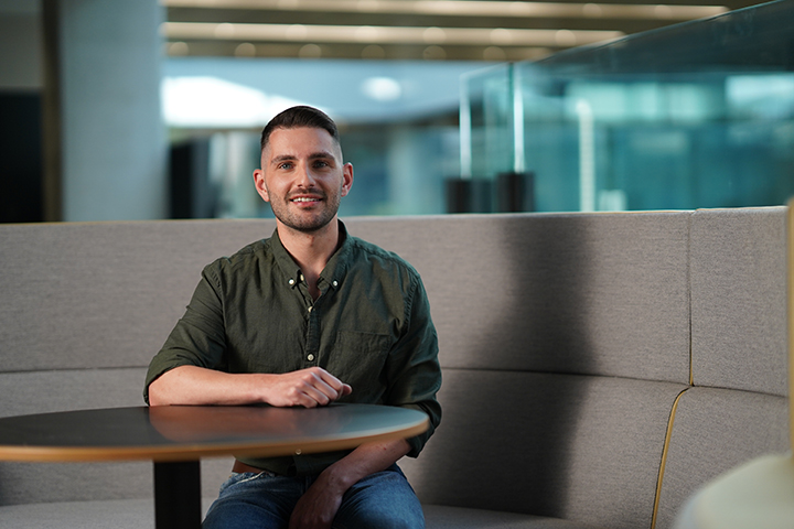 Male student sitting in a library booth