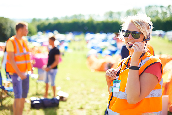 Woman wearing a headset managing an outdoor event