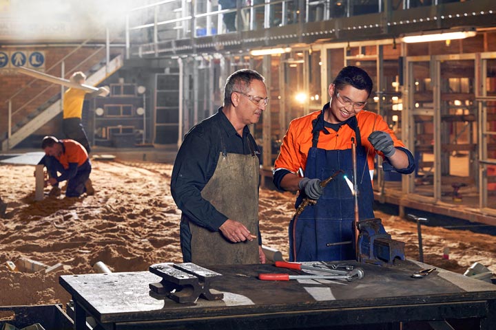 Plumbers working across a job site.