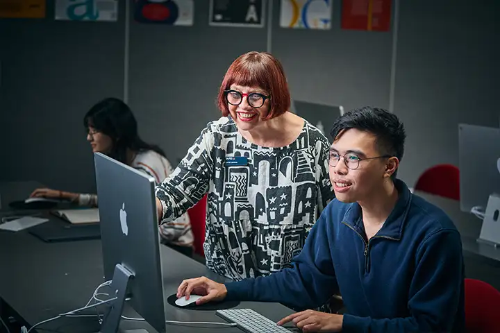 A digital designer working with their supervisor.