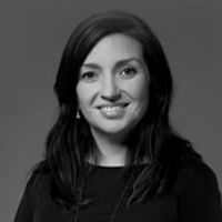 Black and white headshot of Andrea Cainero, smiling.