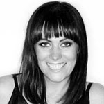 Black and white headshot of Nicky Zimmermann, smiling.