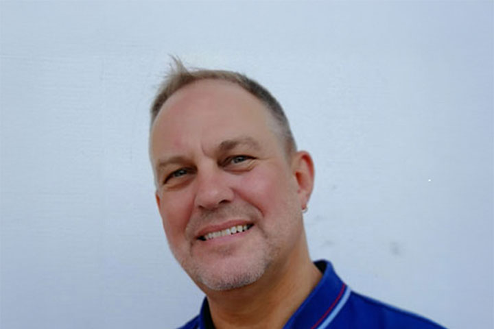 Rod McCrae, Head Teacher of Entertainment Design and Illustration at the TAFE NSW Design Centre, Enmore, is wearing a blue polo shirt and smiling warmly at the camera.