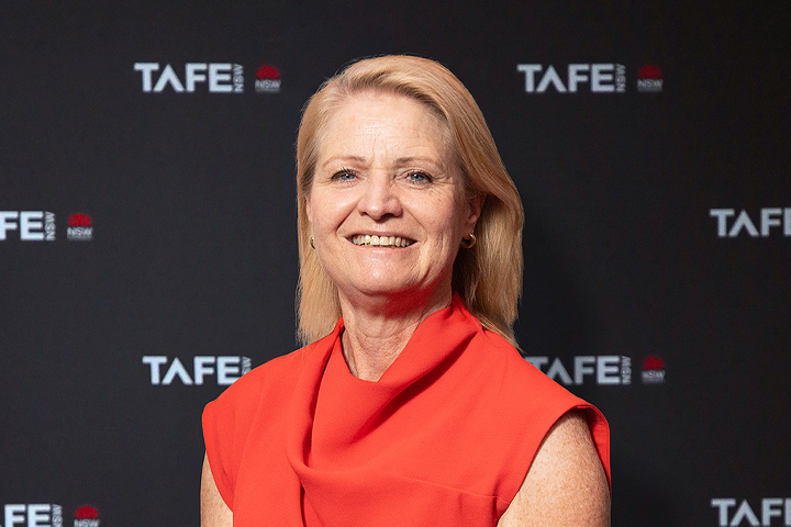 Katrina Troughton is smiling at the camera. She is wearing a bright blue jacket.