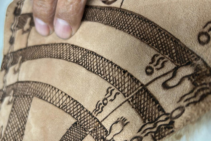 Aboriginal art is displayed on a section of Kangaroo skin.