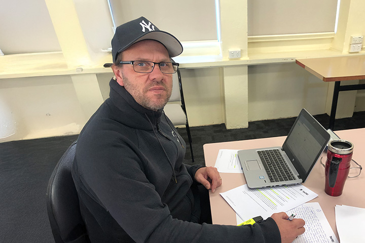 Craig Bain, mature-age student at TAFE NSW Goulburn, studying in the classroom.