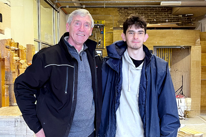 TAFE NSW student Franco Petruzzella stands next to head teacher of stonemasonry Michael Landers in the TAFE NSW Miller stonemasonry workshop.
