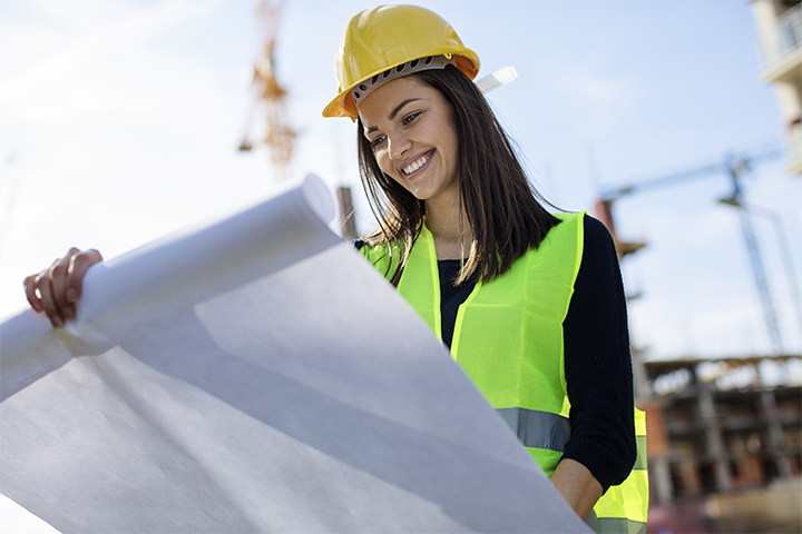 Lady at construction site looking at plans