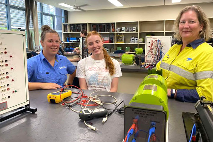 Leonie Davies, Rebecca Napier, Naomi George smiling side-by-side in a workshop