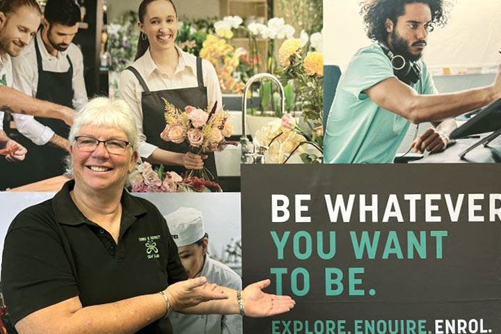 Wendy Daley standing in front of signage pointing to "be whatever you want to be"