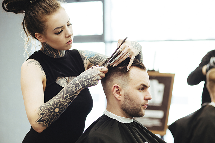 A female barber cutting hair