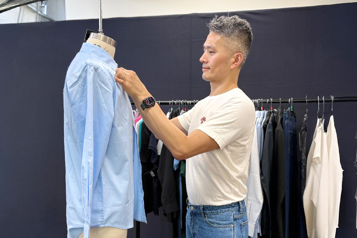 Yao-Chung Chang, a fashion technician and TAFE NSW English student, working on a garment on a mannequin.