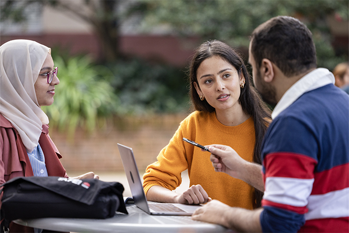 A group of multicultural students having a discussion outside