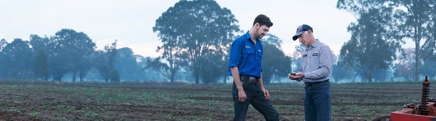 Two people standing together on a farm