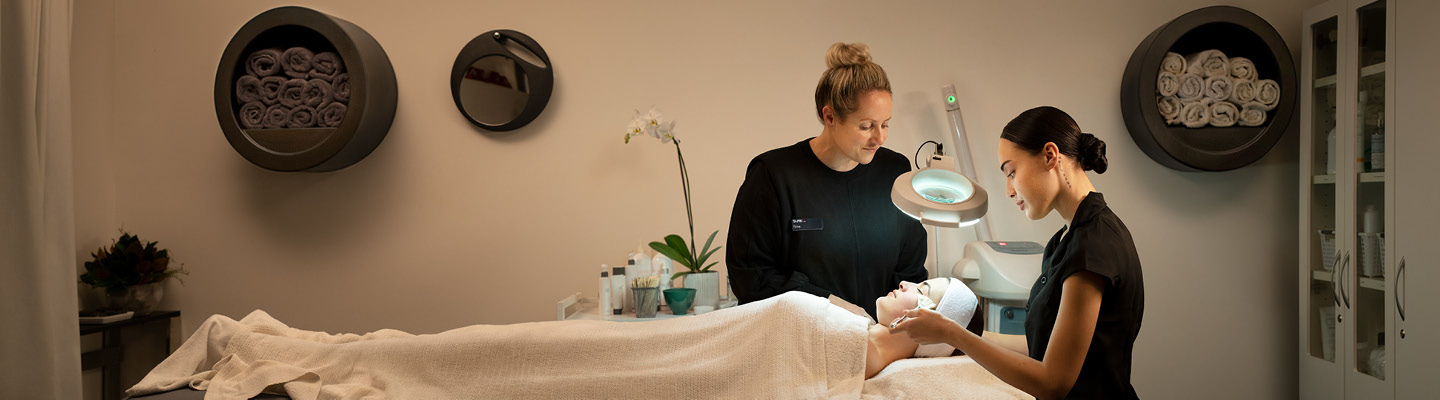 Two beauticians giving a beauty treatment