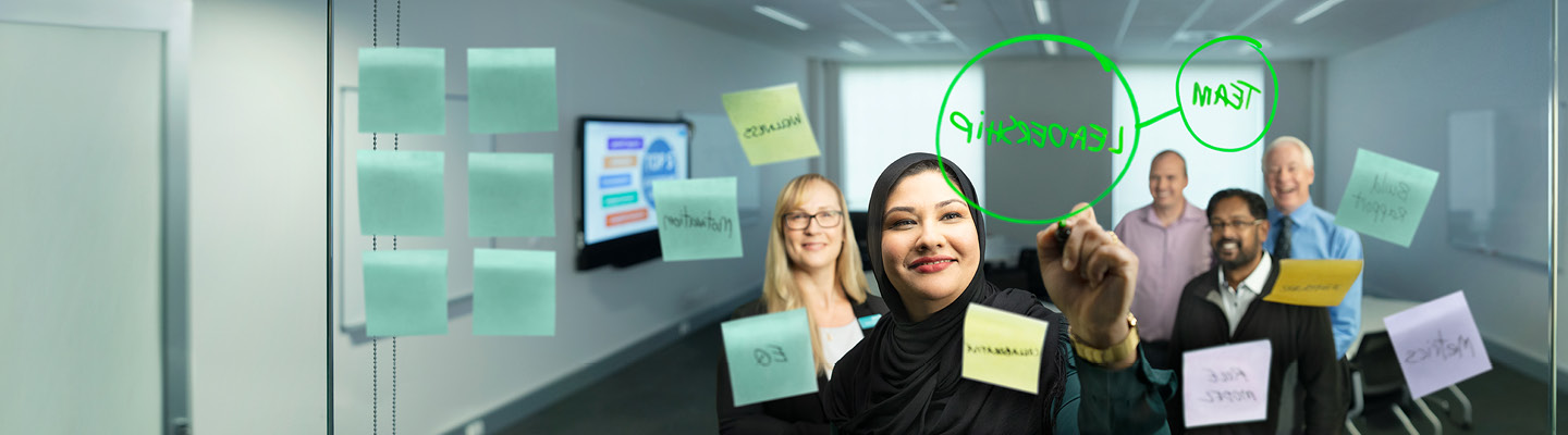 Group of people working in a team meeting.