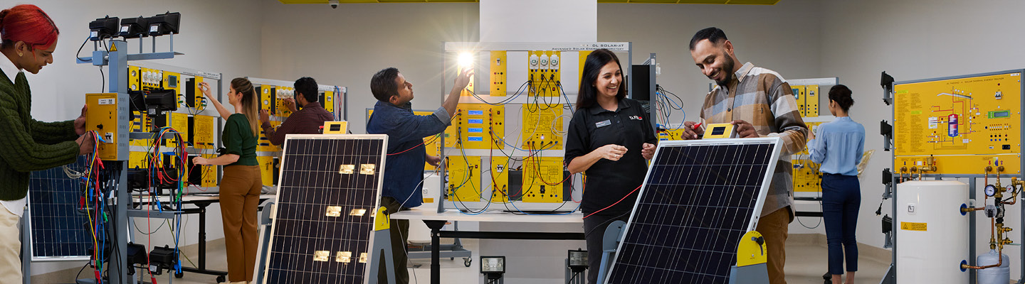 People engaging in hands-on work with electronic panels