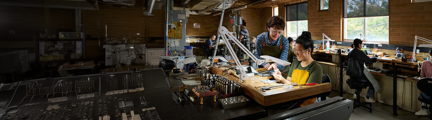 Individuals engaged in jewellery manufacturing at a workshop