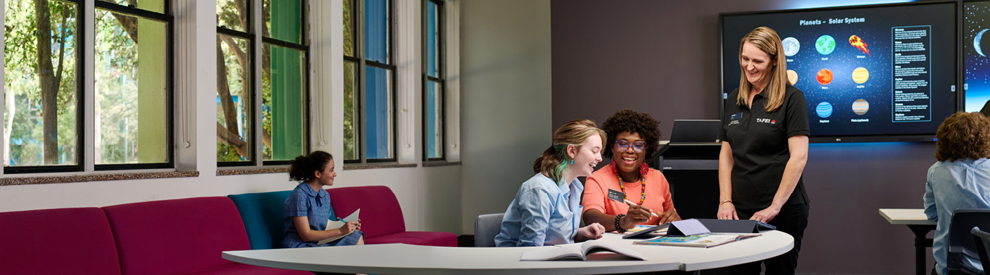 TAFE NSW staff mentoring students in a collaborative learning setting