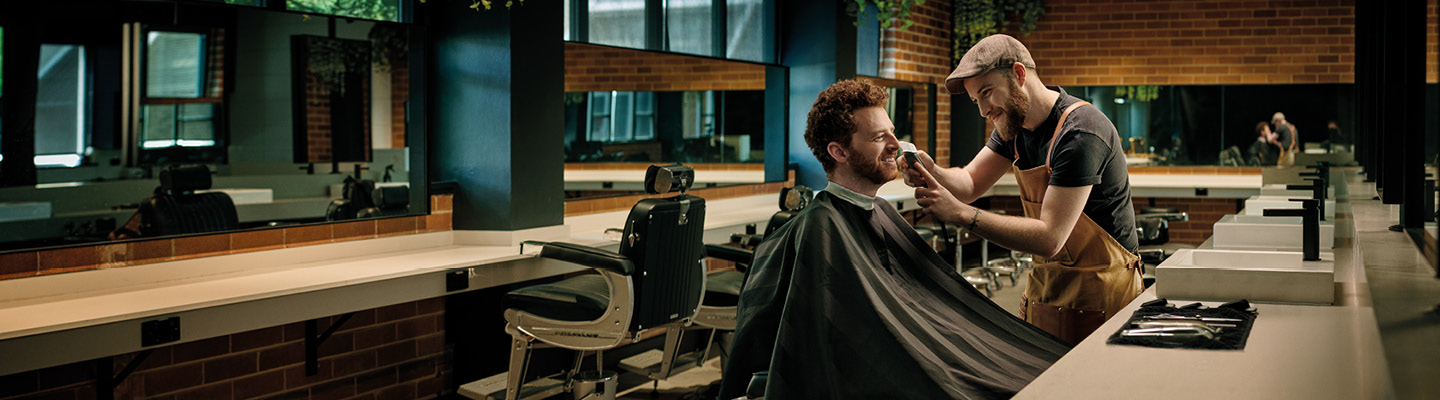 TAFE NSW barbering student gaining hands-on experience in hair cutting and styling