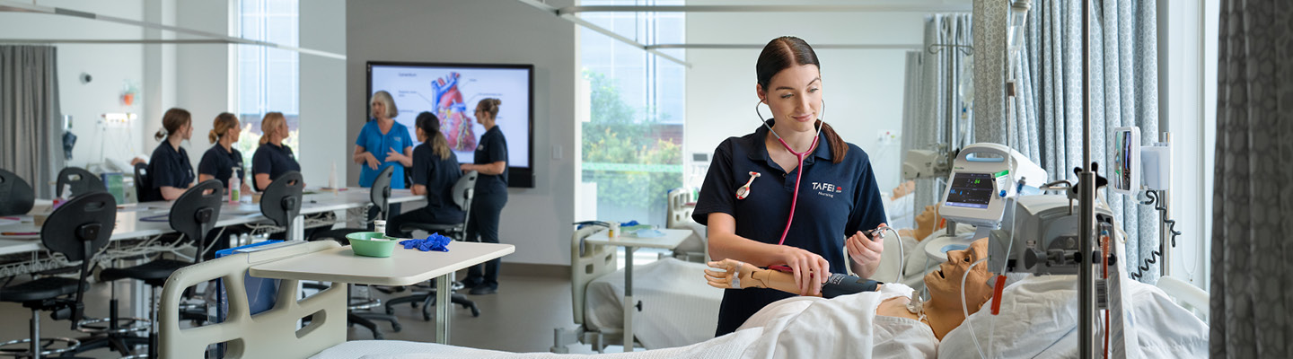 Dedicated female nurse providing care to patient amidst nursing class