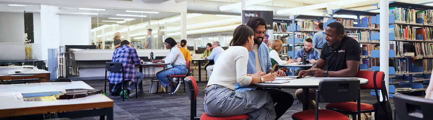 Culturally diverse students learning and collaborating in the TAFE NSW library.