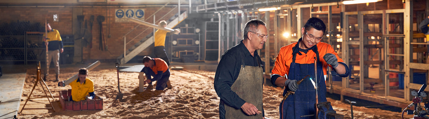 Trades teacher and student working on a job site