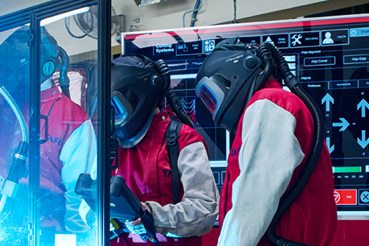 Practical heavy industry skills development with TAFE NSW students in protective gear