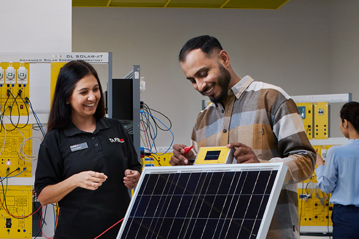 People engaging in hands-on work with electronic panels
