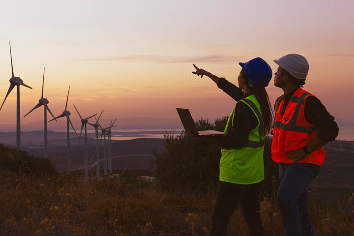 People inspecting windmills