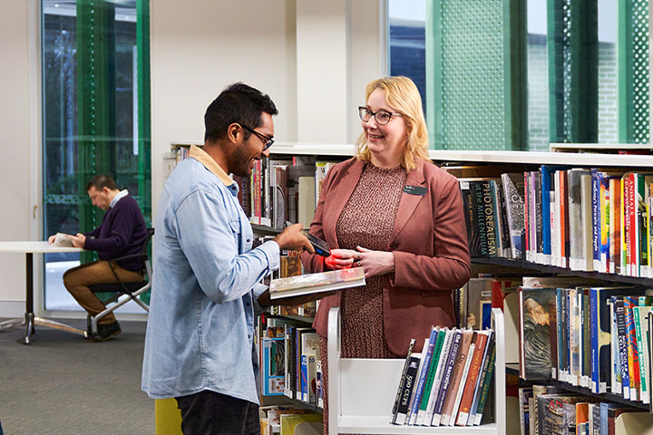 Guest and library staff engaging in conversation and support services.