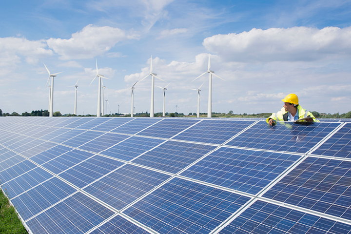 A person with solar panels and wind turbines