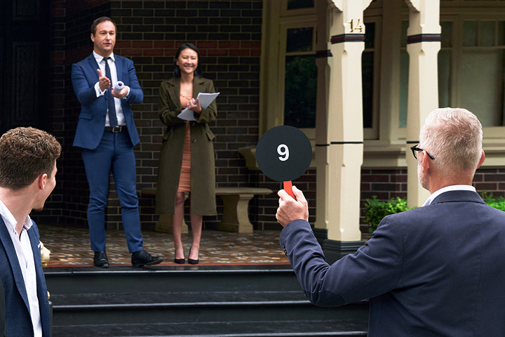 Teacher and students actively participating in a residential auction, gaining practical insights into the dynamics of the property market