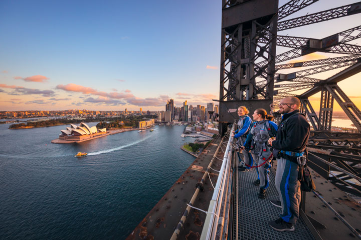 Group of climbers on the Sydney Harbour Bridge overlooking Sydney Harbour and the Opera House.