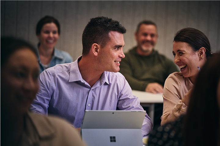 A man and woman smiling in class