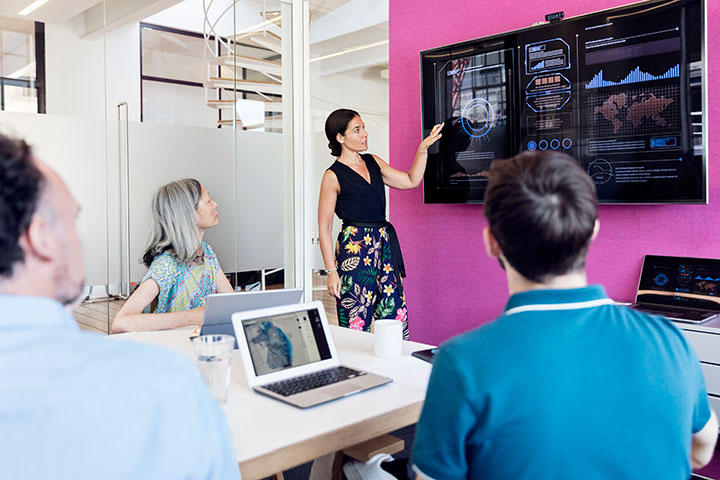 Data presentation by a businesswoman using graphs in a meeting