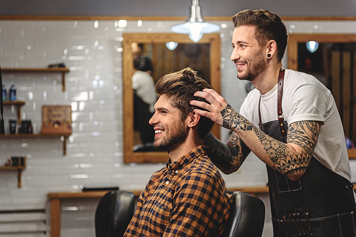 Close-up photograph showcasing the expertise of a hairdresser and the satisfaction of their customer in a salon