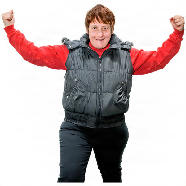 A person in a black vest and red shirt posing with arms raised in a triumphant gesture.